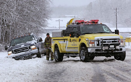 BENEDICT, MD - MARCH 02: A rescue vehicle prepares to pull a stuck truck out of the snow on March 2, 2009 in Benedict, Maryland. The Washington,DC. area was hit with a major snow storm with southern Maryland receiving the worst with 8 to 10 inches of snow.